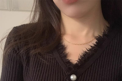 Long-Sleeve V-Neck Fringed Button Ribbed Knit Top