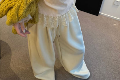 Crewneck Knit Sweater, Sleeveless Lace Camisole, and High-Waist Wide-Leg Trousers