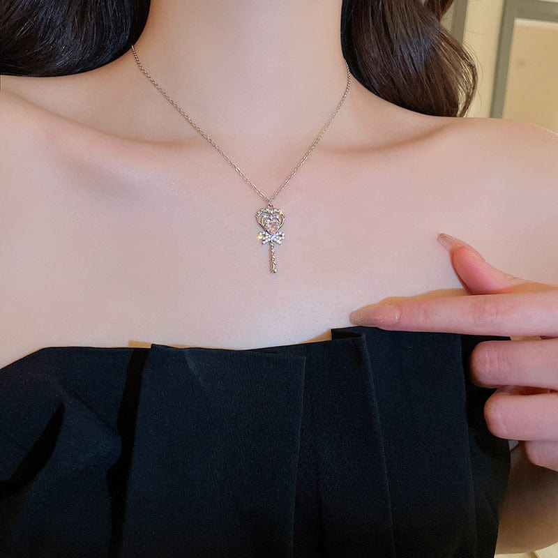 Collier baguette magique en forme de cœur avec nœud papillon